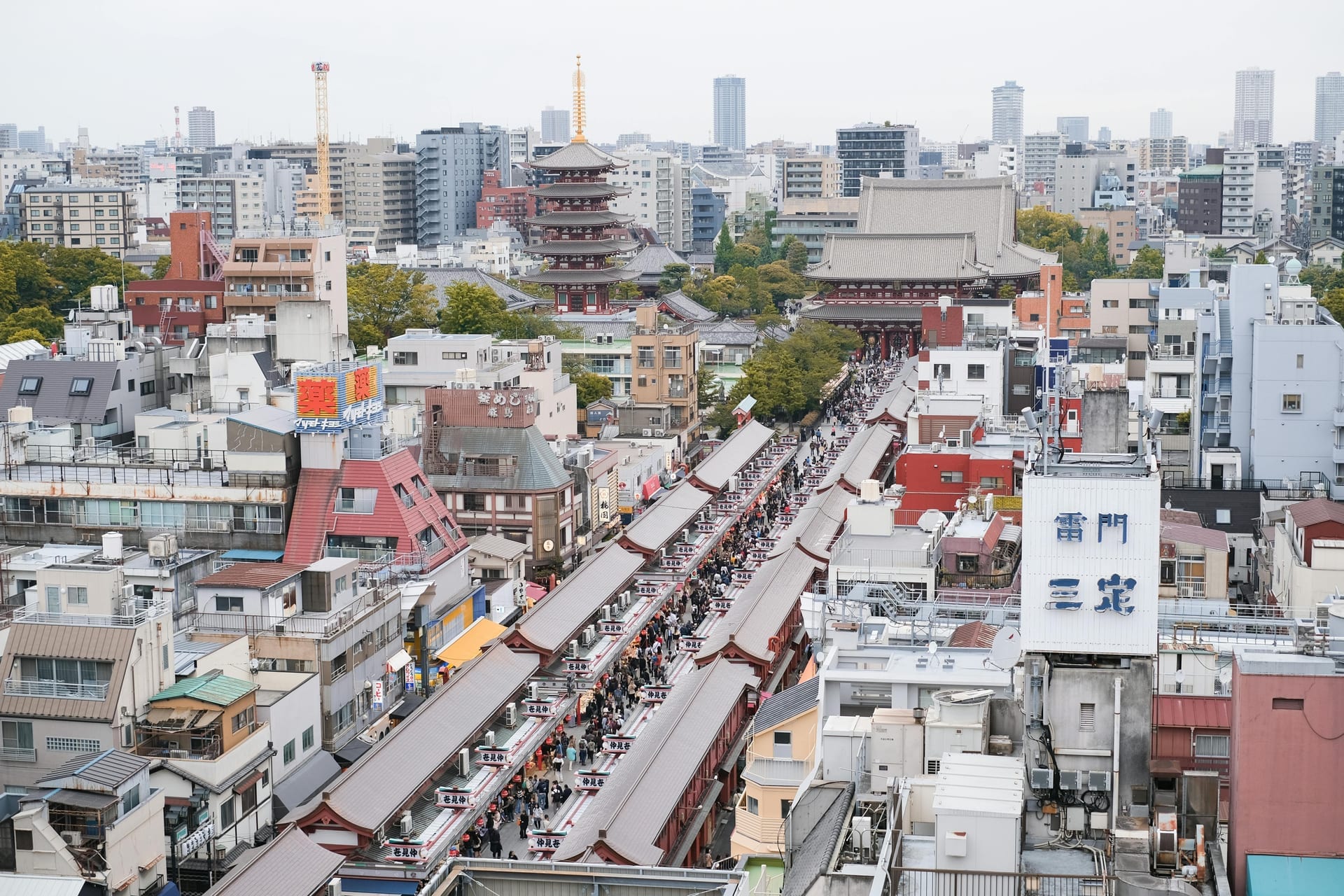 Aerial view looking down Nakamise-dori shopping street toward Senso-ji Temple with the five-story pagoda visible